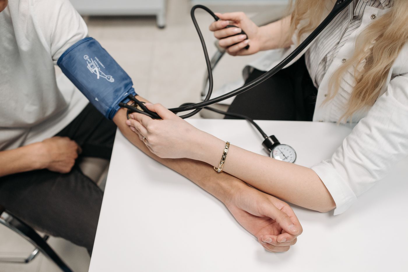 A nurse taking a patient’s blood pressure during a clinical assessment